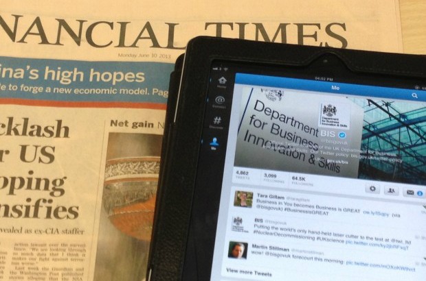 An iPad laying on a copy of the Financial Times.