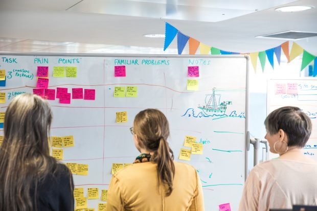 GDS staff standing in front of a whiteboard.